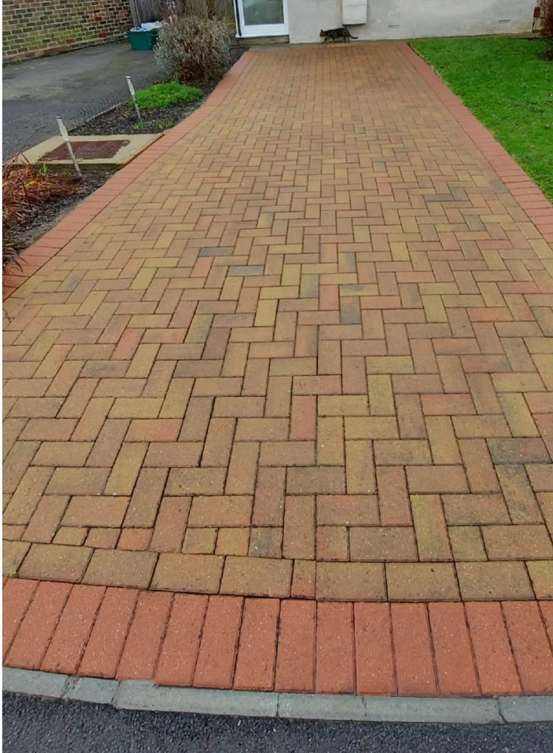 Brick paver walkway after cleaning, bright red brick